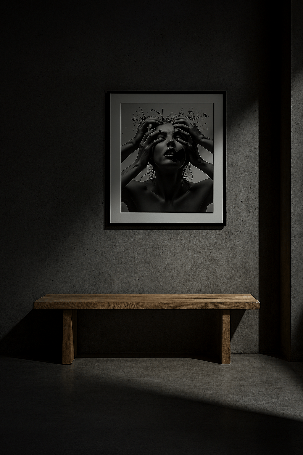 Framed black and white portrait on a dark wall with a wooden bench below.